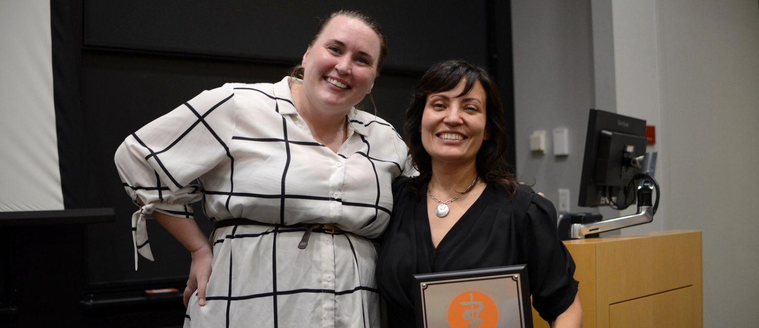 Koranda Walsh standing with an award