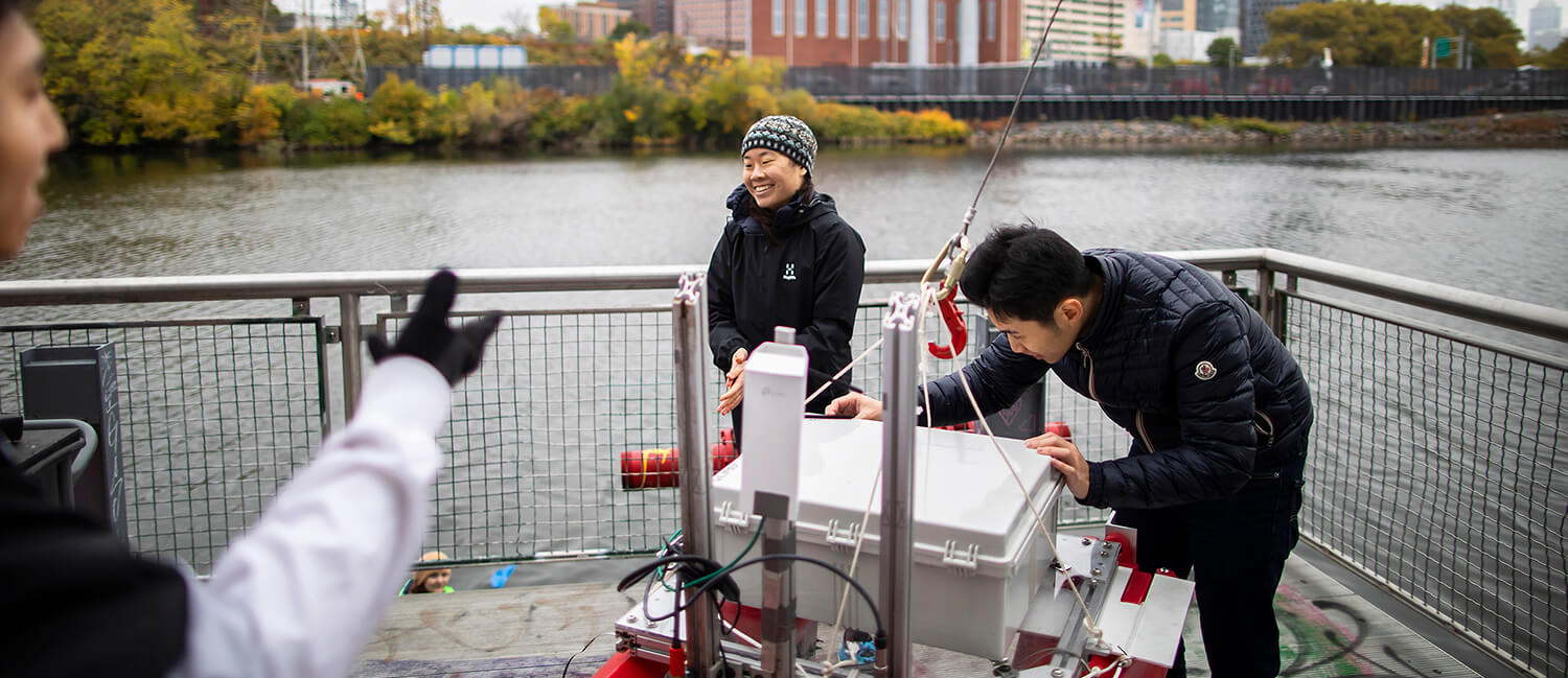 Photo of Alice-Kate-Li and her team working on the dock