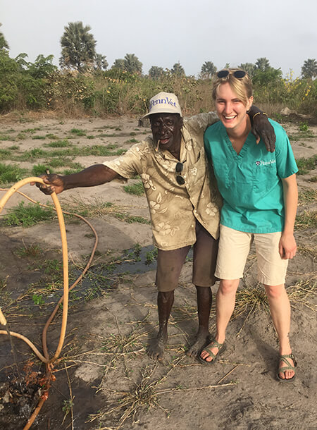 Sainey Badjie (left) was the first person Brianna Parsons (right) hired to help run the Gambia Goat Dairy. Badjie continues to serve as watchman and caretaker for the goats. (Image: Courtesy of Brianna Parsons)