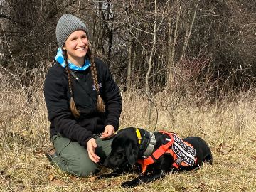 A person in a field with a dog