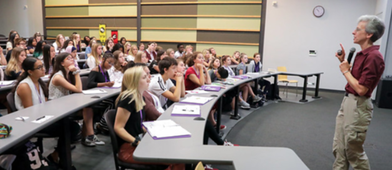 A faculty member at the front of a lecture hall